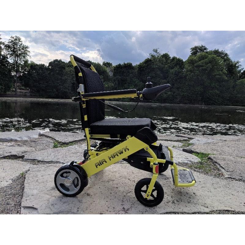 Air Hawk Foldable Electric Wheelchair in yellow, outside
